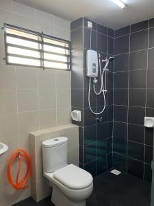 a bathroom with a toilet and a shower at Homestay A&A in Sungai Petani