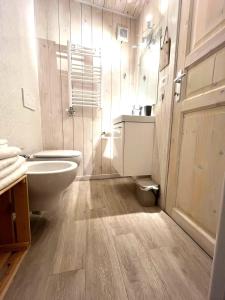 a bathroom with a toilet and a sink at Due cuori e... un Loft nel cuore antico di Aosta in Aosta