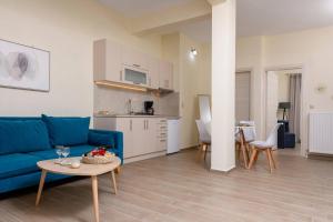 a living room with a blue couch and a table at Chara Sea View Luxury House in Limenas +37 photos