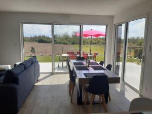 a living room with a couch and a table with chairs at La Maison du Lividig 3 étoiles OT29 in Brignogan-Plages