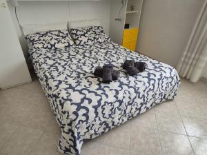 a bedroom with a bed with two stuffed animals on it at Villa Sabaudia in Sabaudia