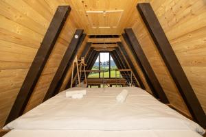a bed in a tiny house with a window at Kuća za odmor Sokolac in Brinje +44 photos