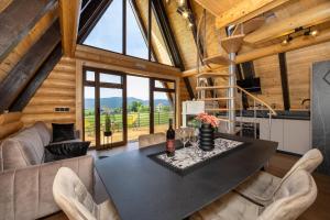 a dining room and living room with a table and chairs at Kuća za odmor Sokolac in Brinje