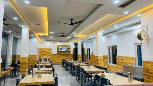 a dining room with wooden tables and chairs at Pine hills resort and restaurant in Barkot