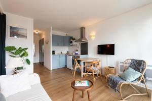 a living room with a couch and a table at Point d'Or in Hossegor
