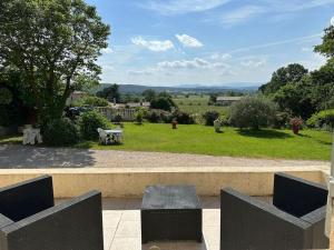 a view of a park with a table and chairs at Maison au calme avec jardin in Brouzet-lès-Alès