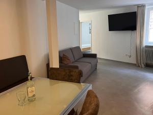 a living room with a couch and a glass table at Gasthof Kreuz in Bad Waldsee