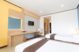 Ένα ή περισσότερα κρεβάτια σε δωμάτιο στο Asia Lampang Hotel