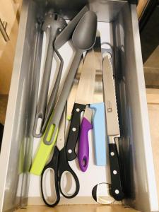 a drawer filled with different types of kitchen utensils at Spacious City Centre flat free parking& superfast WIFI in Edinburgh
