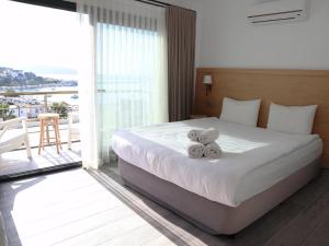 a hotel room with a bed with two teddy bears on it at DORTMEVSİM Hotel in Bodrum City +25 photos