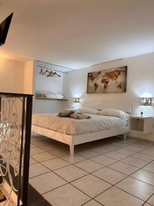 a bedroom with a large bed with two lamps on the wall at Mediterraneo Apartment in Ercolano