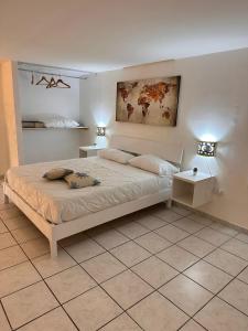a bedroom with a large bed with two night stands at Mediterraneo Apartment in Ercolano