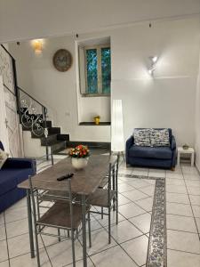 a living room with a table and chairs and a couch at Mediterraneo Apartment in Ercolano