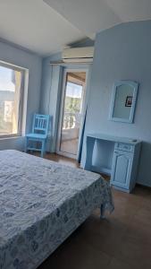 a bedroom with a bed and a view of a balcony at Guest House Chalakov in Sinemorets