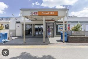 a person standing at a forest hill gas station at Zion Property in Sydenham
