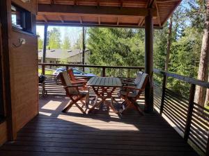 a patio with a table and chairs on a deck at Kylpyla Spa, Saimaa Villa Efrat B8 in Imatra