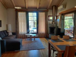 a living room with a couch and a table at Kylpyla Spa, Saimaa Villa Efrat B8 in Imatra