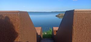 a view of a lake from between two retaining walls at Casa Vacanze Nel Delta del Po in Taglio di Po