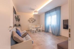 a living room with a couch and a table at Villino in centro con cortile interno, wifi e aria condizionata in Codigoro