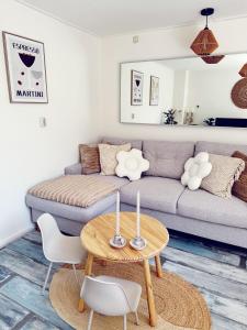 a living room with a couch and a table at Beach House Sea-Esta in Egmond aan Zee