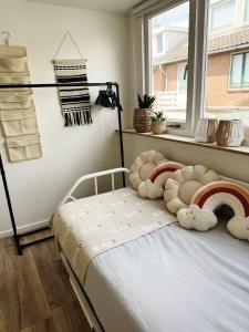 a bedroom with a bed and a window at Beach House Sea-Esta in Egmond aan Zee +75 photos