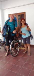 two people are standing next to a bike at Yellow Birds Resort in Anuradhapura