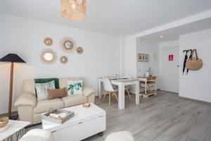a living room with a couch and a table at Apartamento Jávea Puerto in Jávea