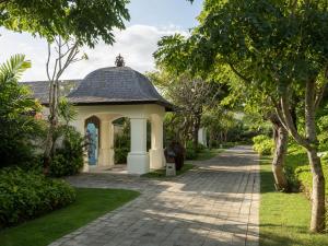 a gazebo in the middle of a path at Jumeirah Bali in Uluwatu