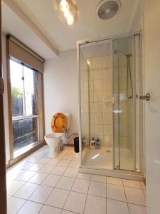 a bathroom with a shower and a toilet at YF Home Sweet Home FREE WIFI 4 bedroom beautiful house in Craigieburn +24 photos