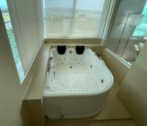 a bath tub in a bathroom with a window at Pagadian Bay Plaza Hotel in Pagadian +15 photos