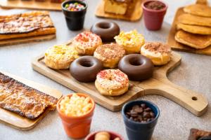 a table with a tray of donuts and other pastries at Hesperia Barcelona Presidente in Barcelona