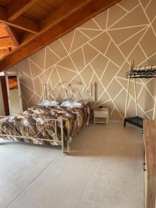 a bedroom with a bed with a geometric wall at Vesux Apartments in Naples