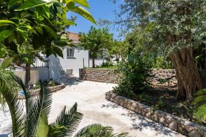 a garden with trees and a stone wall at Villa Talia in Sorrento