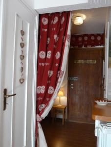 a room with a red curtain and a door at Il Balcone Delle Alpi in Sauze dʼOulx