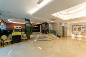 eine Lobby mit Stühlen und eine Treppe in einem Gebäude in der Unterkunft TURIM Europa Hotel in Lissabon