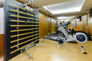 a gym with a treadmill and a fan at TURIM Europa Hotel in Lisbon