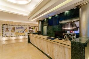 a hotel lobby with a bar with a lamp at TURIM Europa Hotel in Lisbon