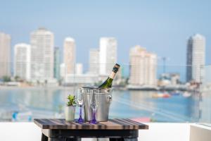 a bottle of wine in a bucket on a table at Playa Hotel - Cavancha in Iquique