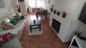 a living room with a couch and a fireplace at La casa de mayfer in Benamahoma