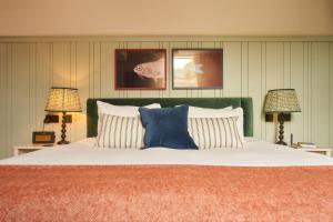 a bedroom with a large bed with two lamps at Mill on the Exe in Exeter