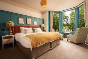 a bedroom with a large bed and a large window at Mill on the Exe in Exeter