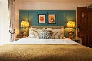 a bedroom with a bed with pillows and two lamps at Mill on the Exe in Exeter