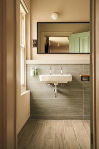 a bathroom with a sink and a mirror at Mill on the Exe in Exeter