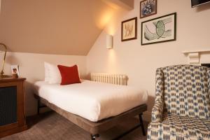 a hotel room with a bed and a chair at Mill on the Exe in Exeter