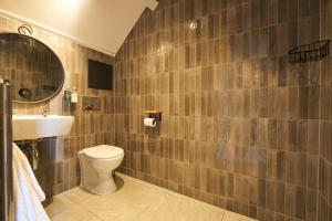 a bathroom with a toilet and a sink at Mill on the Exe in Exeter