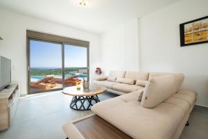 a living room with a couch and a table at Etheria Villa in Chania Town