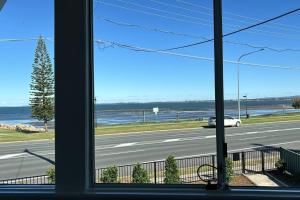 a view from a window of a highway with a car at Vandy Beach Cottage in Clontarf