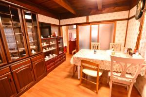 a dining room with a table and chairs at 民泊優雅 in Izumi-Sano