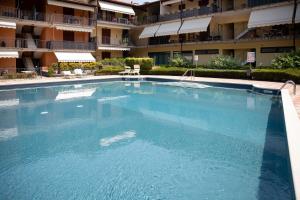 a large swimming pool in front of a building at La casa di Monica con piscina e terrazza in Moniga