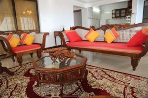 a living room with couches with colorful pillows at Beytul Habaib in Lamu
